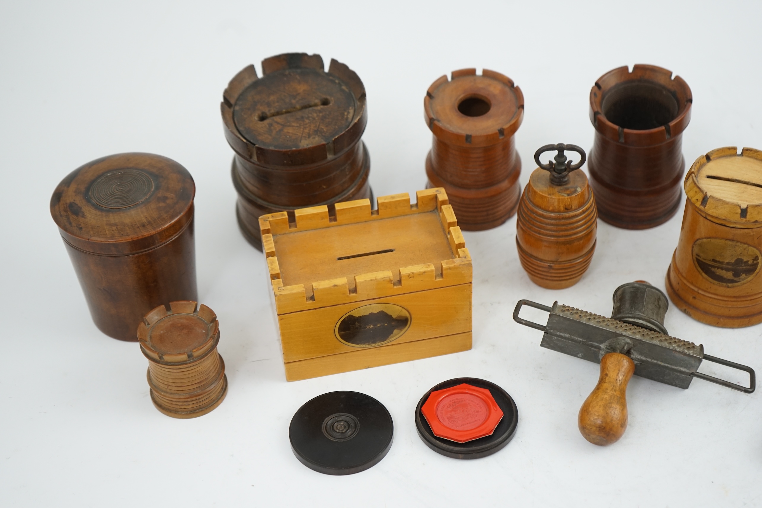 A collection of Victorian and Edwardian treen comprising castellated boxes, nutcrackers, kitchenalia and a glass holder. Condition - fair to good